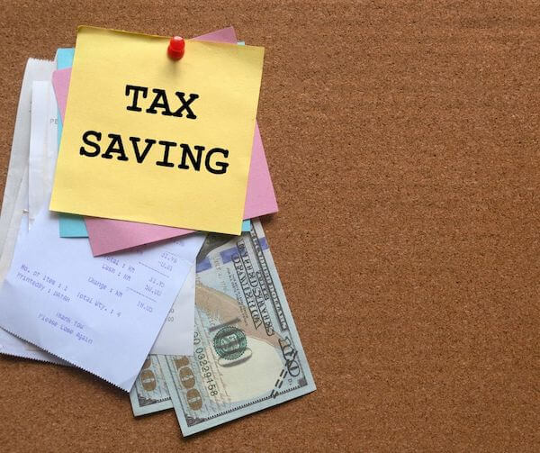 a sticky note on a receipt and dollar bills 4 tax-saving strategies