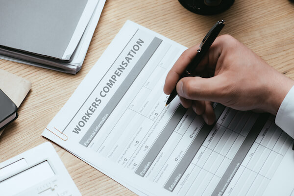 a man holding a pen above a form helping our clients